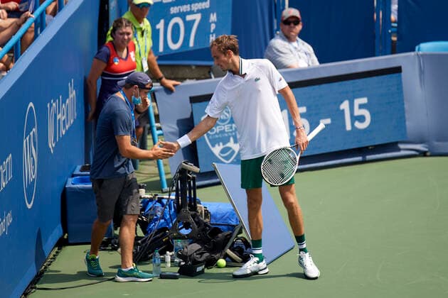 CINCINNATI, OH - AUGUST 21: A camera operator shakes hands with Daniil Medvedev of Russia after Medvedev accidentally crashed in to the camera during the semifinal match on day 7 of the Western & Southern Open at the Lindner Family Tennis Center in Mason, Ohio on August 21, 2021. (Photo by Shelley Lipton Icon Sportswire) TENNIS: AUG 21 Western & Southern Open Icon210821424