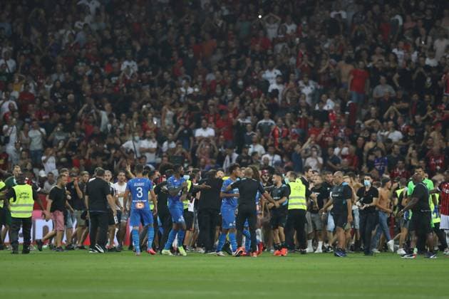 Nice, France, 22nd August 2021. Fans spill onto the pitch to interrupt the game after the Dimitri Payet of Olympique De Marseille threw an object back into the crown that was intially thrown in his direction during the Lique 1 match at Allianz Riviera Stadium, Nice. Picture credit should read: Jonathan Moscrop Sportimage EDITORIAL USE ONLY. No use with unauthorised audio, video, data, fixture lists, club league logos or live services. Online in-match use limited to 120 images, no video emulation. No use in betting, games or single club league player publications. SPI-1148-0017
