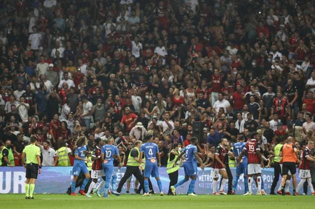 Nice, France, 22nd August 2021. Fans spill onto the pitch to interrupt the game after the Dimitri Payet of Olympique De Marseille threw an object back into the crown that was intially thrown in his direction during the Lique 1 match at Allianz Riviera Stadium, Nice. Picture credit should read: Jonathan Moscrop Sportimage EDITORIAL USE ONLY. No use with unauthorised audio, video, data, fixture lists, club league logos or live services. Online in-match use limited to 120 images, no video emulation. No use in betting, games or single club league player publications. SPI-1148-0019