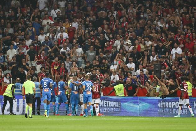 Nice, France, 22nd August 2021. Fans spill onto the pitch to interrupt the game after the Dimitri Payet of Olympique De Marseille threw an object back into the crown that was intially thrown in his direction during the Lique 1 match at Allianz Riviera Stadium, Nice. Picture credit should read: Jonathan Moscrop Sportimage EDITORIAL USE ONLY. No use with unauthorised audio, video, data, fixture lists, club league logos or live services. Online in-match use limited to 120 images, no video emulation. No use in betting, games or single club league player publications. SPI-1148-0022