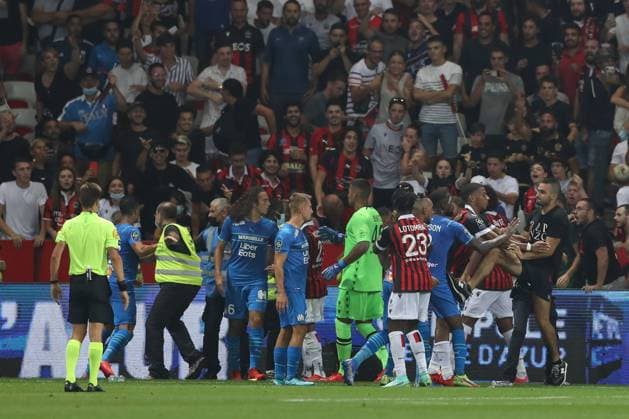 Nice, France, 22nd August 2021. Jean-Clair Todibo of OGC Nice pushes an OGC Nice fan back towards the crowd as he kicks out at Gerson Santos Da Silva of Olympique De Marseille during the Lique 1 match at Allianz Riviera Stadium, Nice. Picture credit should read: Jonathan Moscrop Sportimage EDITORIAL USE ONLY. No use with unauthorised audio, video, data, fixture lists, club league logos or live services. Online in-match use limited to 120 images, no video emulation. No use in betting, games or single club league player publications. SPI-1148-0087