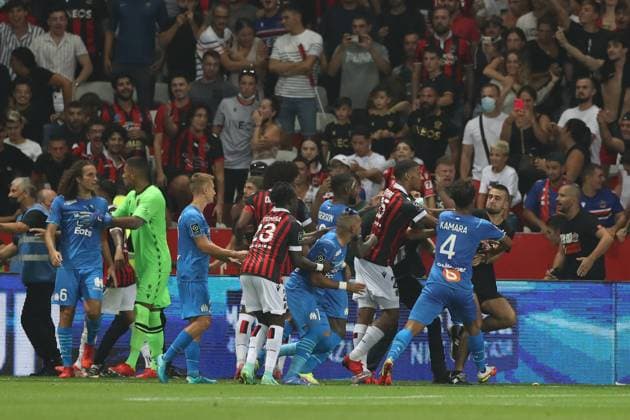 Nice, France, 22nd August 2021. Jean-Clair Todibo of OGC Nice and Boubacar Kamara of Olympique De Marseille push an OGC Nice fan back towards the crowd as he kicks out at Gerson Santos Da Silva of Olympique De Marseille during the Lique 1 match at Allianz Riviera Stadium, Nice. Picture credit should read: Jonathan Moscrop Sportimage EDITORIAL USE ONLY. No use with unauthorised audio, video, data, fixture lists, club league logos or live services. Online in-match use limited to 120 images, no video emulation. No use in betting, games or single club league player publications. SPI-1148-0089