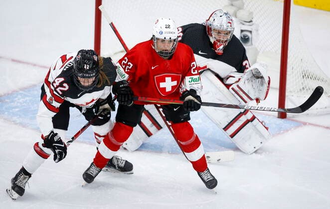 August 24, 2021, Calgary, ab, Canada: Switzerland s Sinja Leemann, centre, holds her position while being is checked by Canada s Claire Thompson in front of goalie Emerance Maschmeyer during second period IIHF Women s World Championship, WM, Weltmeisterschaft hockey action in Calgary, Tuesday, Aug. 24, 2021. Emerance Maschmeyer, Claire Thompson, Sinja Leemann  - ZUMAc35_ 20210824_zaf_c35_088 Copyright: xJeffxMcintoshx