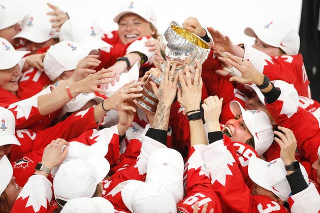 Overtime goal scorer and Canada captain, Marie-Philip Poulin, rt, holds up the winning cup, surrounded by other players, after defeating the USA in IIHF Women s World Championship, WM, Weltmeisterschaft gold medal play in Calgary, Alberta, Canada on Aug. 31, 2021. digital photo by Larry MacDougal Marie-Philip Poulin
