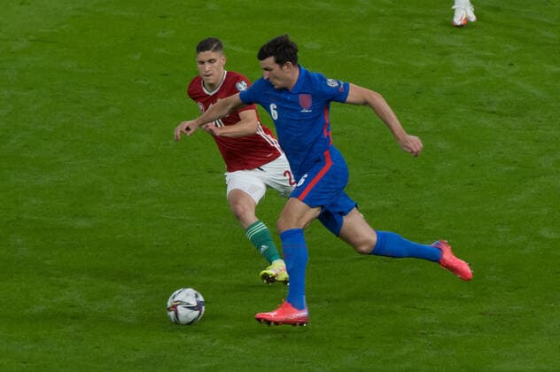 (210903) -- BUDAPEST, Sept. 3, 2021 -- Hungary s Roland Sallai (L) vies with England s Harry Maguire during the FIFA World Cup, WM, Weltmeisterschaft, Fussball Qatar 2022 qualification Group I football match between Hungary and England in Budapest, Hungary, on Sept. 2, 2021. (Photo by Xinhua) (SP)HUNGARY-BUDAPEST-FOOTBALL-FIFA WORLD CUP QATAR 2022-QUALIFIERS-GROUP I AttilaxVolgyi 