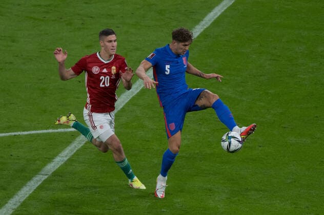 (210903) -- BUDAPEST, Sept. 3, 2021 -- Hungary s Roland Sallai (L) vies with England s John Stones during the FIFA World Cup, WM, Weltmeisterschaft, Fussball Qatar 2022 qualification Group I football match between Hungary and England in Budapest, Hungary, on Sept. 2, 2021. (Photo by Xinhua) (SP)HUNGARY-BUDAPEST-FOOTBALL-FIFA WORLD CUP QATAR 2022-QUALIFIERS-GROUP I AttilaxVolgyi 
