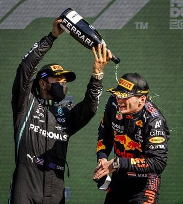 ZANDVOORT Lewis Hamilton Mercedes sprays champagne over Max Verstappen Red Bull after winning the Dutch Grand Prix at the Zandvoort circuit REMKO DE WAAL Grand Prix xVIxANPxSportx xxANPxIVx 436909560