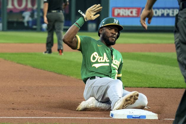 Oakland Athletics center fielder Starling Marte (2) slides safely into third base against the Kansas City Royals at Kauffman Stadium in Kansas City, Missouri on Tuesday, September 14, 2021.  KCP20210914105 KYLExRIVAS