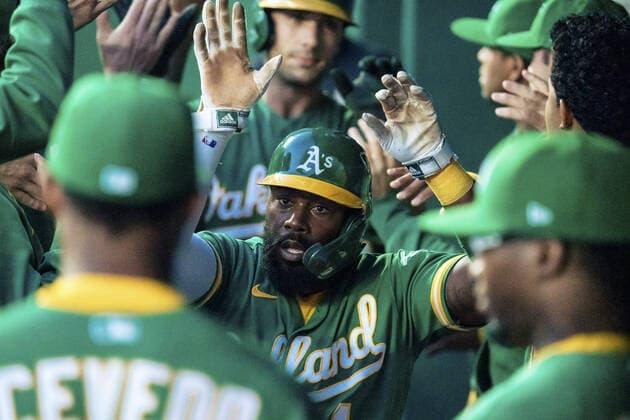 Oakland Athletics second baseman Josh Harrison (1) celebrates scoring against the Kansas City Royals in the first inning at Kauffman Stadium in Kansas City, Missouri on Tuesday, September 14, 2021.  KCP20210914106 KYLExRIVAS