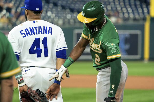 Kansas City Royals first baseman Carlos Santana (41) and Oakland Athletics center fielder Starling Marte (2) poke fun at each other at first base during the fifth inning at Kauffman Stadium in Kansas City, Missouri on Tuesday, September 14, 2021.  KCP20210914113 KYLExRIVAS