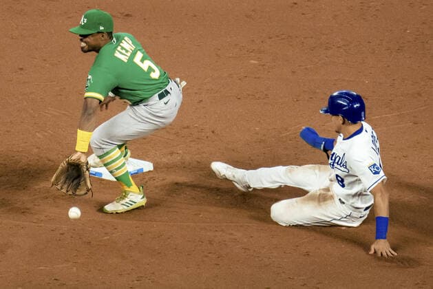 Kansas City Royals second baseman Nicky Lopez (8) slides safely past the tag from Oakland Athletics second baseman Tony Kemp (5) in the sixth inning at Kauffman Stadium in Kansas City, Missouri on Tuesday, September 14, 2021.  KCP20210914122 KYLExRIVAS