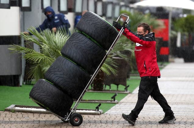 SOCHI, RUSSIA - SEPTEMBER 25, 2021: A member of the Alfa Romeo Racing team moves tires in a paddock area at the Sochi Autodrom racing circuit hosting the 2021 Formula One Russian Grand Prix. The third practice session of the 2021 F1 Russian Grand Prix has been canceled amid heavy rains in Sochi. Sergei Fadeichev TASS  TS111DDA