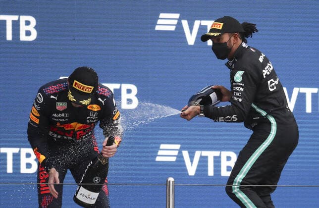 SOCHI, RUSSIA - SEPTEMBER 26, 2021: 2nd placed, Red Bull Racing F1 Team driver Max Verstappen (L) and 1st placed Mercedes AMG Petronas F1 Team driver Lewis Hamilton spray champagne during the podium ceremony for the 2021 Formula One Russian Grand Prix at the Sochi Autodrom racing circuit. Sergei Fadeichev TASS  TS11216A