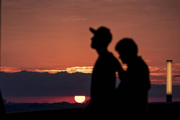 Fans walk the upper deck as the sun sets before the Kansas City Royals verse the Minnesota Twins game at Kaufman Stadium in Kansas City, Missouri on Friday, October 1, 2021.  KCP20211001102 KYLExRIVAS