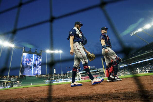 Minnesota Twins starting pitcher John Gant (33) and catcher Ryan Jeffers (27) head to the dugout before taking on the Kansas City Royals at Kaufman Stadium in Kansas City, Missouri on Friday, October 1, 2021.  KCP20211001104 KYLExRIVAS