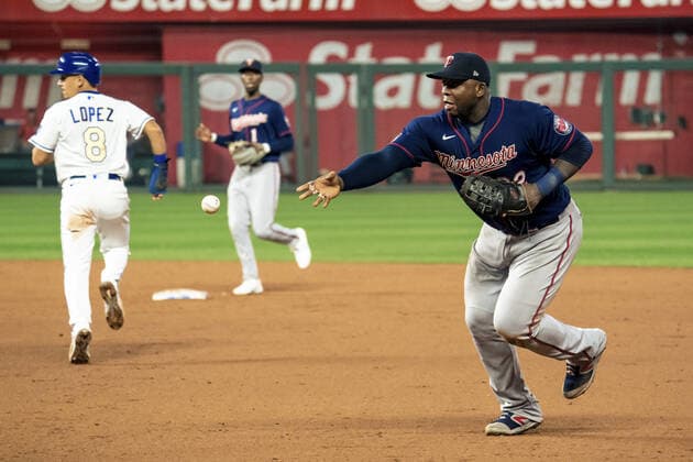 Minnesota Twins first baseman Miguel Sano (22) tosses the ball back to first to get the Kansas City Royals runner out at first at Kaufman Stadium in Kansas City, Missouri on Friday, October 1, 2021.  KCP20211001117 KYLExRIVAS