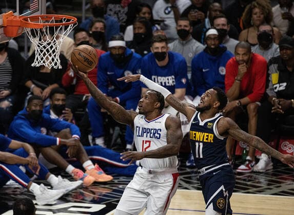 October 4, 2021, Los Angeles, California, USA: Eric Bledsoe 12 of the Los Angeles Clippers goes for a layup past Monte Morris 11 of the Denver Nuggets during their preseason NBA, Basketball Herren, USA game on Monday October 4, 2021 at the Staples Center in Los Angeles, California. Clippers defeat Nuggets, 103 - 102. PI Los Angeles USA - ZUMAp124 20211004_zaa_p124_001 Copyright: xJAVIERxROJASx