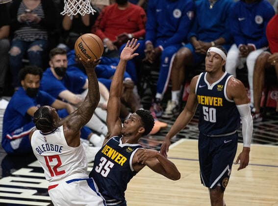 October 4, 2021, Los Angeles, California, USA: Eric Bledsoe 12 of the Los Angeles Clippers goes for a layup past PJ Dozier 35 of the Denver Nuggets during their preseason NBA, Basketball Herren, USA game on Monday October 4, 2021 at the Staples Center in Los Angeles, California. Clippers defeat Nuggets, 103 - 102. PI Los Angeles USA - ZUMAp124 20211004_zaa_p124_002 Copyright: xJAVIERxROJASx