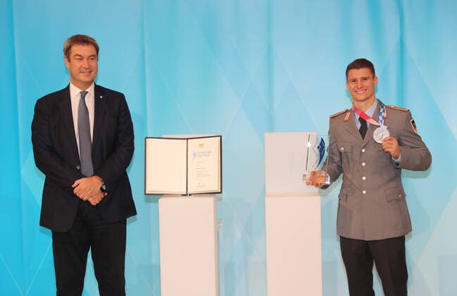 The Bavarian Prime Minister Dr Markus Söder awards the Bavarian Sports Award to the Bavarian medal winners from Tokyo Markus Söder and Lukas Dauser Munich Bavaria Germany State Chancellery Kuppelsaal