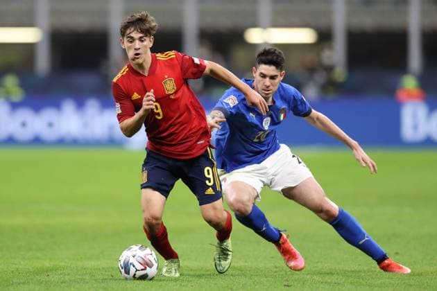 Milan, Italy, 5th October 2021. Gave of Spain shields the ball from Alessandro Bastoni of Italy during the UEFA Nations League match at Giuseppe Meazza, Milan. Picture credit should read: Jonathan Moscrop Sportimage EDITORIAL USE ONLY. No use with unauthorised audio, video, data, fixture lists, club league logos or live services. Online in-match use limited to 120 images, no video emulation. No use in betting, games or single club league player publications. SPI-1229-0048