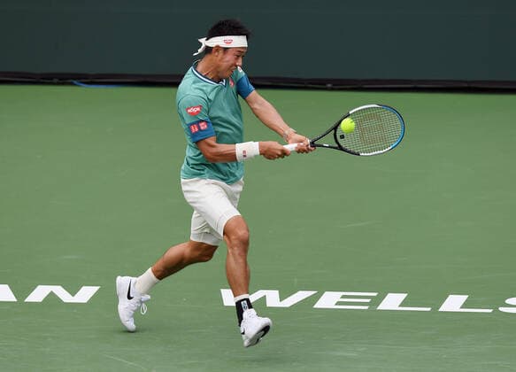 INDIAN WELLS, CA - OCTOBER 07: Kei Nishikori of Japan returns a shot during a tennis match played on October 7, 2021 at the BNP Paribas Open played at the Indian Wells Tennis Garden in Indian Wells, CA. (Photo by John Cordes Icon Sportswire) TENNIS: OCT 07 BNP Paribas Open Icon506211007839