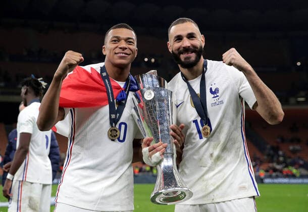 (211011) -- MILAN, Oct. 11, 2021 -- France s Karim Benzema (R) and Kylian Mbappe pose with the trophy after the UEFA Nations League final match between France and Spain in Milan, Italy, Oct. 10, 2021. (Photo by Emilio Andreoli UEFA Pool handout via Xinhua ) (SP)ITALY-MILAN-FOOTBALL-UEFA NATIONS LEAGUE-FINAL-FRANCE VS SPAIN JinxMamengnitonglian 