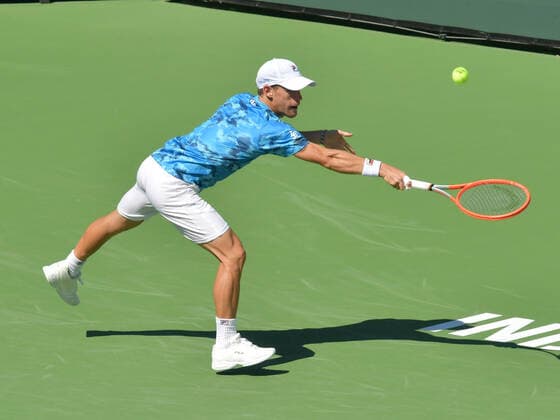 INDIAN WELLS, CA - OCTOBER 11: Diego Schwartzsman (ARG) stretching for a wide backhand during his men s singles match at the BNP Paribas Open on October 11, 2021, at the Indian Wells Tennis Garden in Indian Wells, CA. ) (Photo by Cynthia Lum Icon Sportswire TENNIS: OCT 11 BNP Paribas Open Icon250211011651