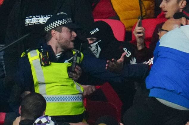 Mandatory Credit: Photo by Javier Garcia Shutterstock (12534018es) A Hungary fan tries to grab the radio of a police officer during clashes in the stands England v Hungary, FIFA World Cup, WM, Weltmeisterschaft, Fussball 2022 Qualifying, Group I, Football, Wembley Stadium, London, UK - 12 Oct 2021 EDITORIAL USE ONLY No use with unauthorised audio, video, data, fixture lists, club league logos or live services. Online in-match use limited to 120 images, no video emulation. No use in betting, games or single club league player publications. England v Hungary, FIFA World Cup 2022 Qualifying, Group I, Football, Wembley Stadium, London, UK - 12 Oct 2021 EDITORIAL USE ONLY No use with unauthorised audio, video, data, fixture lists, club league logos or live services. Online in-match use limited to 120 images, no video emulation. No use in betting, games or single club league player publications.  Copyright: xJavierxGarcia Shutterstockx 12534018es