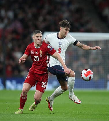 (211013) -- LONDON, Oct. 13, 2021 -- Hungary s Roland Sallai is challenged by England s John Stones during the FIFA World Cup, WM, Weltmeisterschaft, Fussball Qatar 2022 qualification group I match between England and Hungary in London, Britain on Oct. 12, 2021. (Photo by Xinhua) (SP)BRITAIN-LONDON-FOOTBALL-WORLD CUP QUALIFYING-ENGLAND VS HUNGARY MatthewxImpey 