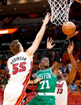 Sport Bilder des Tages Boston Celtics guard Dennis Schroder (C) shoots between Miami Heat forward Duncan Robinson (L) and center Bam Adebayo (R), during a NBA, Basketball Herren, USA basketball game at FTX Arena in Miami, Florida, USA, 15 October 2021. Boston Celtics at Miami Heat !ACHTUNG: NUR REDAKTIONELLE NUTZUNG!  Copyright: xRHONAxWISEx AME164 20211016-dbfc7d6ba9b1cdadb7f9d3c9307e264607fbb00f