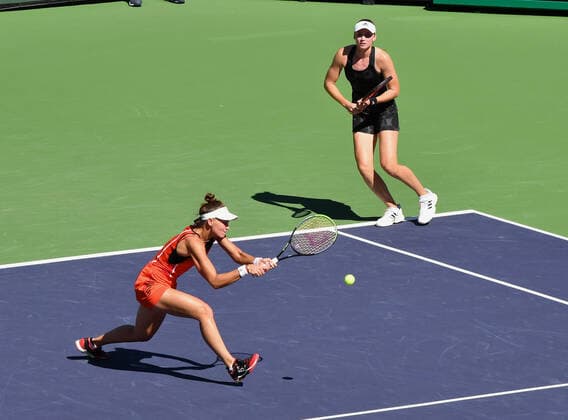 INDIAN WELLS, CA - OCTOBER 16: Veronika Kudermetova of Russia hits the ball while her partner Elena Rybakina of Kazakhstan moves along the baseline during a finals doubles tennis match played on October 16, 2021 at the BNP Paribas Open at the Indian Wells Tennis Garden in Indian Wells, CA. (Photo by John Cordes Icon Sportswire) TENNIS: OCT 16 BNP Paribas Open Icon506211016041