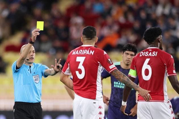Monaco, Monaco, 4th November 2021. The referee Cuneyt Cakir of Turkey shows a yellow card to Guillermo Maripan of AS Monaco during the UEFA Europa League match at Stade Louis II, Monaco. Picture credit should read: Jonathan Moscrop Sportimage EDITORIAL USE ONLY. No use with unauthorised audio, video, data, fixture lists, club league logos or live services. Online in-match use limited to 120 images, no video emulation. No use in betting, games or single club league player publications. SPI-1284-0010