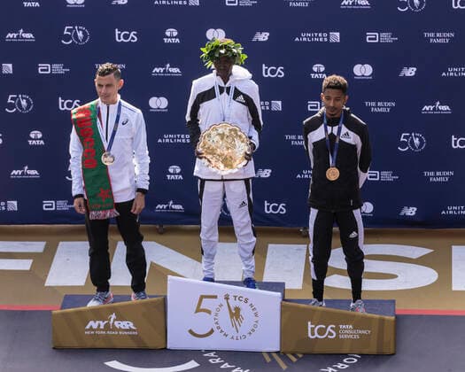 50th TCS New York City Marathon Winners of Men professional athletes of 50th TCS NYC marathon stand a podium in Central Park at finish line. Mohamed Reda El Aaraby of Morocco winner of 2nd place, Albert Korir of Kenya winner of 1st place and Eyob Faniel of Italy winner of 3rd place. Albert Korir clocked 2:08:22 for the marathon. NYC marathon was canceled in 2020 because of COVID-19 pandemic and returned in 2021. It attracted most top runners of the world as well as thousands more runners and spectators. New York New York United States Copyright: LevxRadin
