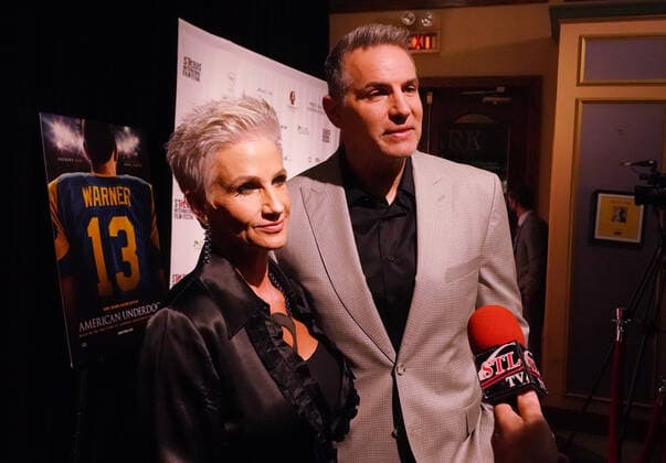 Kurt and Brenda Warner stop to talk to reporters on the red carpet during a special screening of the new movie featuring Warner, American Underdog, at the Tivoli Theater in University City, Missouri on Monday, November 8, 2021. The movie depicts Warner from a supermarket clerk to a Super Bowl Champion with the St. Louis Rams.  SLP2021110898 BILLxGREENBLATT