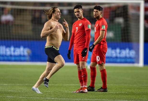 November 12, 2021, EDMONTON, AB, CANADA: Team Canada s Stephen Eustaquio (7) and Jonathan Osorio (10) watch as a man runs across the field during second half World Cup qualifier soccer action against Costa Rica in Edmonton on Friday, November 12, 2021. Stephen Eustáquio Jonathan Osorio  - ZUMAc35_ 20211112_zaf_c35_073 Copyright: xJasonxFransonx