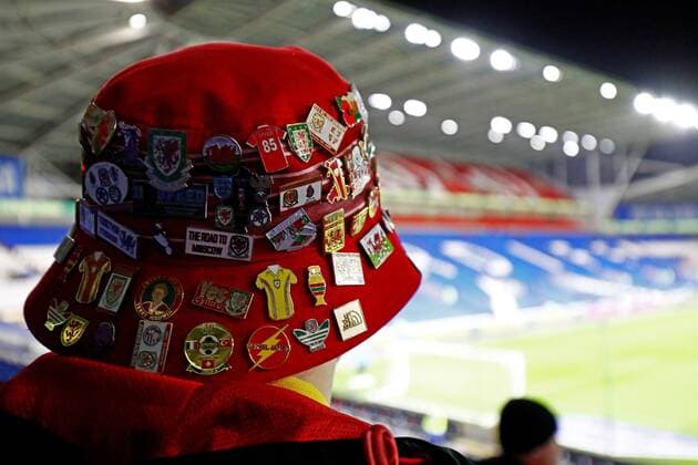 Mandatory Credit: Photo by James Marsh Shutterstock (12604863b) A fan is seen with a hat covered in badges. Wales v Belgium, FIFA World Cup, WM, Weltmeisterschaft, Fussball 2022 Qualifying, Group E, Football, Cardiff City Stadium, Cardiff, UK - 16 Nov 2021 EDITORIAL USE ONLY No use with unauthorised audio, video, data, fixture lists, club league logos or live services. Online in-match use limited to 120 images, no video emulation. No use in betting, games or single club league player publications. Wales v Belgium, FIFA World Cup 2022 Qualifying, Group E, Football, Cardiff City Stadium, Cardiff, UK - 16 Nov 2021 EDITORIAL USE ONLY No use with unauthorised audio, video, data, fixture lists, club league logos or live services. Online in-match use limited to 120 images, no video emulation. No use in betting, games or single club league player publications.  Copyright: xJamesxMarsh Shutterstockx 12604863b