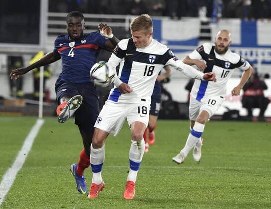 Fußball, WM Quali, Finnland - Frankreich France s France s Dayot Upamericano and Finland s Jere Uronen (18) with Teemu Pukki (background) during the FIFA World Cup, WM, Weltmeisterschaft, Fussball Qatar 2022 Group D qualification match Finland vs France at the Helsinki Olympic Stadium in Helsinki, Finland on Tuesday, 16th Nov., 2021 Helsinki Finland LKFTJ20211116215603VWLO  Copyright: xJussixNukarix
