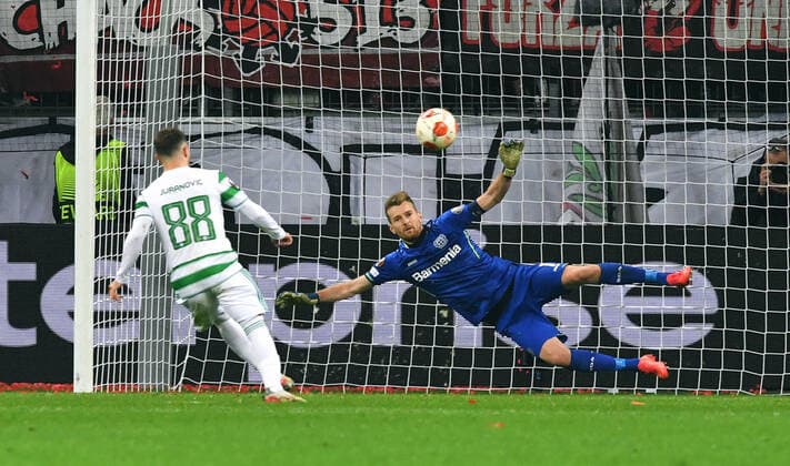 Football, UEFA Europa League, Men, 2021 2022 season, Group G, Matchday 5, BayArena Leverkusen, Bayer Leverkusen black Celtic Glasgow white Josip Juranovic CTG converts penalty against Lukas Hradecky LEV Action UEFA REGULATIONS PROHIBIT ANY USE OF PHOTOGRAPHS AS IMAGE SEQUENCES AND OR QUASI VIDEO