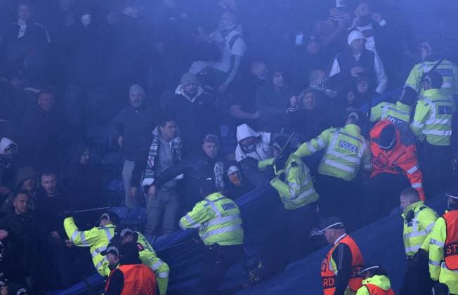 Leicester, England, 25th November 2021. Police draw their batons to keep the Legia Warsaw fans back during the UEFA Europa League match at the King Power Stadium, Leicester. Picture credit should read: Darren Staples Sportimage EDITORIAL USE ONLY. No use with unauthorised audio, video, data, fixture lists, club league logos or live services. Online in-match use limited to 120 images, no video emulation. No use in betting, games or single club league player publications. SPI-1341-0063
