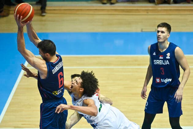 Serbia s Nemanja Dangubic and Belgium s Ismael Bako fight for the ball during a match of the national basketball team of Belgium, the Red Lions, against the national team, Nationalteam of Serbia, a qualification game for the 2023 World Championship, WM, Weltmeisterschaft men, in the Group A (match 2 6), Sunday 28 November 2021. LAURIExDIEFFEMBACQ  x3145238x