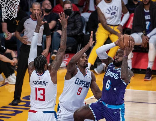 December 3, 2021, Los Angeles, California, USA: Paul George 13 and Serge Ibaka 9 of the Los Angeles Clippers defend against LeBron James 6 of the Los Angeles Lakers during their regular season NBA, Basketball Herren, USA game on Friday December 3, 2021 at the Staples Center in Los Angeles, California. Lakers lose to Clippers, 115-119. PI Los Angeles USA - ZUMAp124 20211203_zaa_p124_041 Copyright: xJAVIERxROJASx