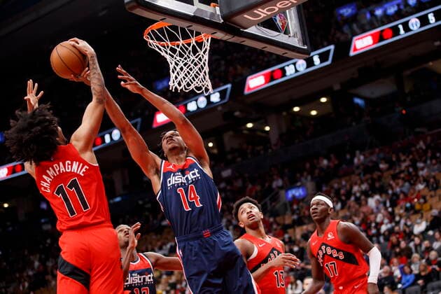 December 5, 2021, Toronto, ON, CANADA: Washington Wizards forward Isaiah Todd (14) and Toronto Raptors forward Justin Champagnie (11) battle in the air for the ball during second half of NBA, Basketball Herren, USA action in Toronto, Sunday, Dec. 5, 2021. Raptors Wizards NBA Action  - ZUMAc35_ 20211205_zaf_c35_234 Copyright: xColexBurstonx