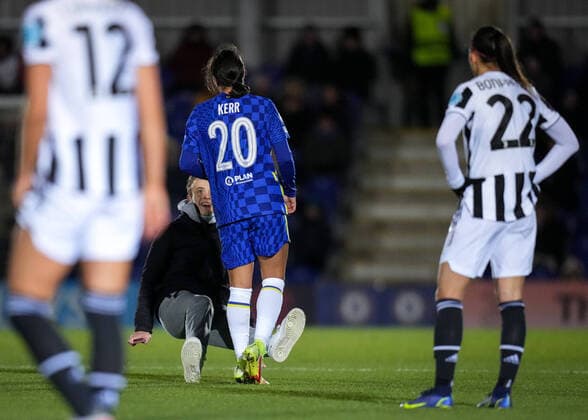 Sam Kerr of Chelsea shoulder barges over a pitch invader who ran on trying to take selfies during the UEFA Women s Champions League match between Chelsea Women and Juventus at the Kingsmeadow Stadium, Kingston, England on 8 December 2021. Copyright: xAndyxRowlandx PMI-4604-0003