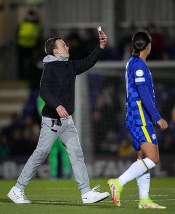 A pitch invader tries to take selfies with Sam Kerr of Chelsea during the UEFA Women s Champions League match between Chelsea Women and Juventus at the Kingsmeadow Stadium, Kingston, England on 8 December 2021. Copyright: xAndyxRowlandx PMI-4604-0015