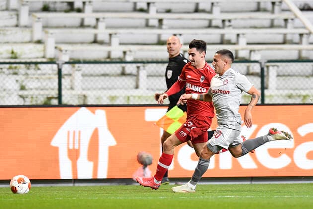Antwerp s Jelle Bataille and Olympiacos Rony Lopes fight for the ball during an Europa League game between Belgian soccer team Royal Antwerp FC and Greek soccer team Olympiacos F.C., Thursday 09 December 2021, in Antwerp, Belgium, on the sixth and last day in Group D of the UEFA Europa League group stage. TOMxGOYVAERTS  x3152849x