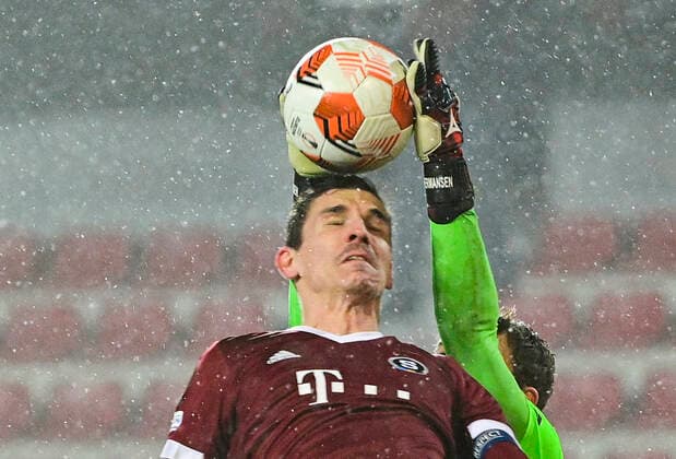 Mads Hermansen, goalkeeper of Brondby, right, makes a save ahead of David Pavelka of Sparta during the UEFA Europa League group A soccer match Sparta Praha vs Brondby Copenhagen in Prague, Czech Republic, December 9, 2021. (CTKxPhoto RomanxVondrous) CTKPhotoP2021120910367 