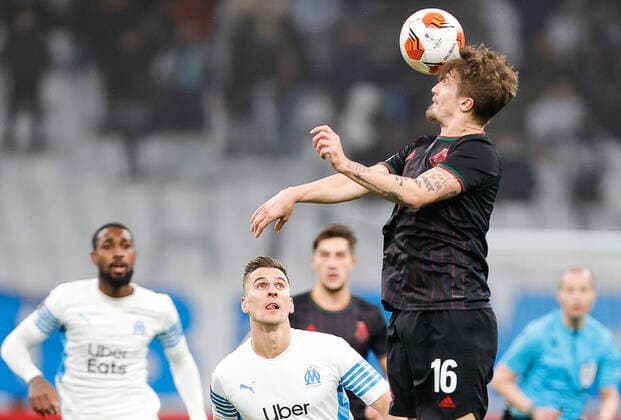 MARSEILLE, FRANCE - DECEMBER 9, 2021: Marseilleâ€™s Arkadiusz Milik (L) and Lokomotiv s Tin Jedvaj in action in the 2021 22 UEFA Europa League Group E Round 6 match between Olympique de Marseille and Lokomotiv Moscow at the Orange Velodrome Stadium. Mikhail Japaridze TASS  TS11B4E3