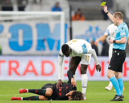 MARSEILLE, FRANCE - DECEMBER 9, 2021: Chief referee William Collum shows the yellow card to Marseille s Papa Gueye in the 2021 22 UEFA Europa League Group E Round 6 match between Olympique de Marseille and Lokomotiv Moscow at the Orange Velodrome Stadium. Mikhail Japaridze TASS  TS11B4E9