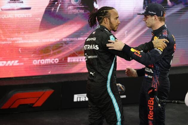 (211213) -- ABU DHABI, Dec. 13, 2021 -- Red Bull driver Max Verstappen (R) of the Netherlands and Mercedes Lewis Hamilton of Britain celebrate after the Formula One Abu Dhabi Grand Prix in Abu Dhabi, the United Arab Emirates, Dec. 12, 2021. Red Bull driver Max Verstappen of the Netherlands has won the world champion of 2021. (SP)UAE-ABU DHABI-F1-GRAND PRIX WuxZhuangtonglian 