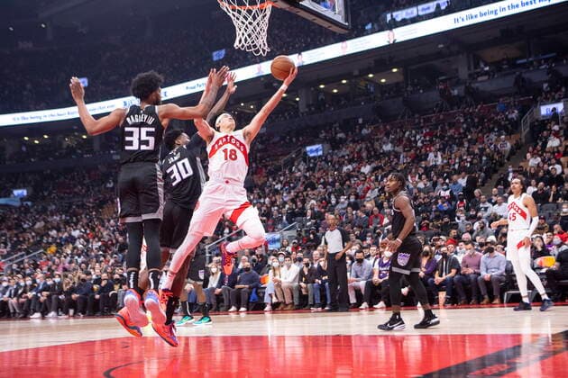 December 13, 2021, Toronto, ON, CANADA: Toronto Raptors Yuta Watanabe (18) scores on Sacramento Kings Damian Jones (30) and teammate Marvin Bagley III during first half NBA, Basketball Herren, USA basketball action in Toronto, Monday, Dec. 13, 2021. Yuta Watanabe ; Damian Jones; Marvin Bagley III  - ZUMAc35_ 20211213_zaf_c35_098 Copyright: xChrisxYoungx
